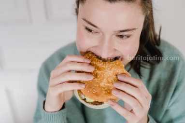 Ilustrasi seseorang yang sedang makan makanan berat cepat saji (sumber: pexels)