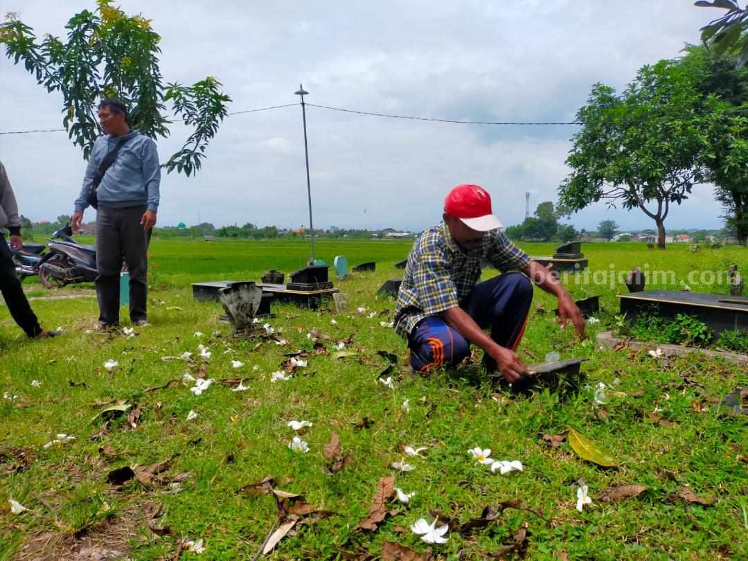 Khoiron warga Kelurahan Glanggang, Kecamatan Beji, Kabupaten Pasuruan saat menunjukan batu nisan yang sudah hancur.