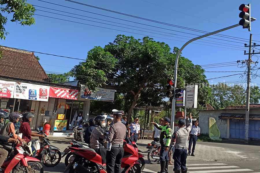 Pelaksanaan ujicoba traffic light di simpang 4 Desa Brahu Kecamatan Siman Ponorogo. (Foto/Endra Dwiono/Beritajatim.com)