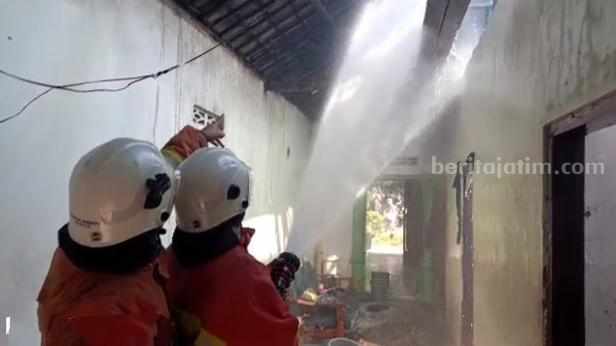 Petugas Damkar BPBD Kabupaten Mojokerto berupaya memadamkan api yang membakar rumah di Dusun Sumolawang RT 02 RW 01, Desa Sumolawang, Kecamatan Puri, Kabupaten Mojokerto. [Foto : ist]