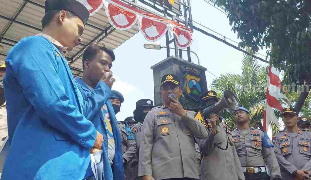 Kapolres Tuban AKBP Suryono saat meminta maaf kepada PMII Tuban saat demo di depan Polres. [Foto:Diah Ayu/beritajatim.com]