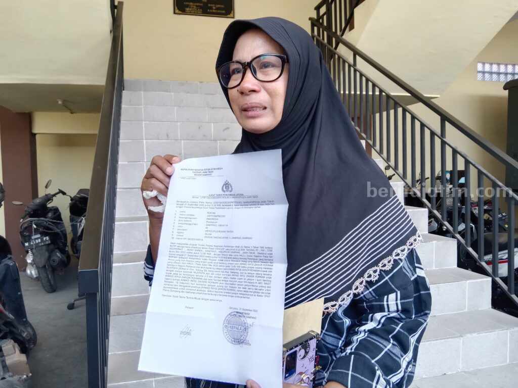 Rofiah saat menunjukan surat laporan dugaan penculikan anak ke Polres Sampang (Foto: Zamachsari/beritajatim.com)