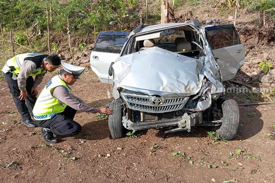 Petugas dari Satlantas Polres Pacitan saat memeriksa mobil yang terlibat laka lantas tunggal. (Foto/Satlantas Polres Pacitan)