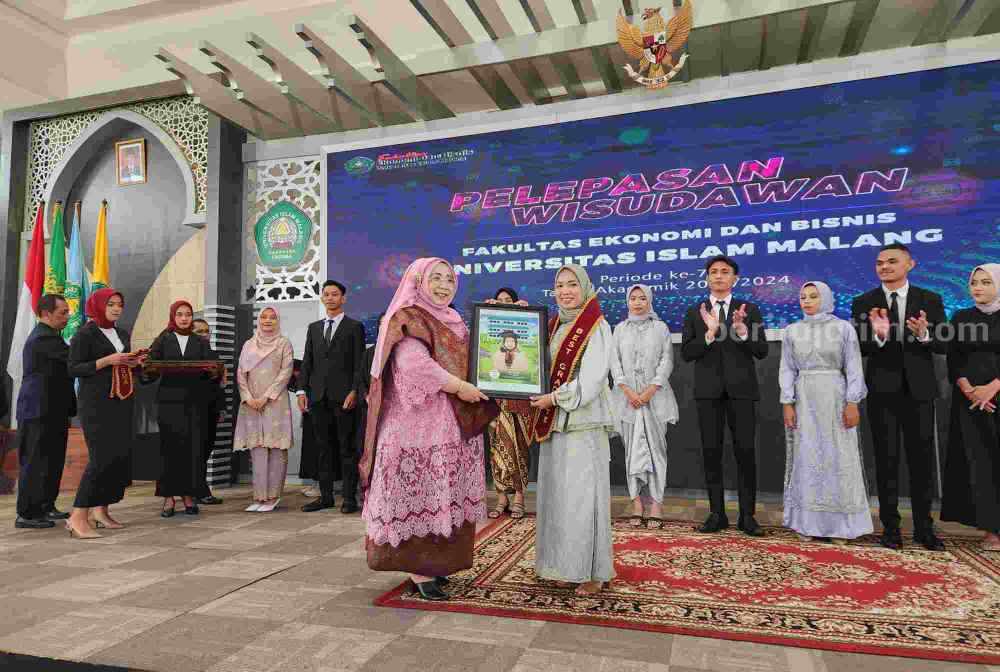 Dekan memberi apresiasi kepada lulusan terbaik FEB Unisma (Foto: Dani Alifian/beritajatim.com)