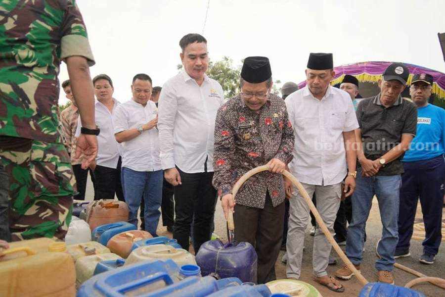 Pj Bupati Pasuruan saat melakukan pemberian air bersih kepada masyarakat terdampak.