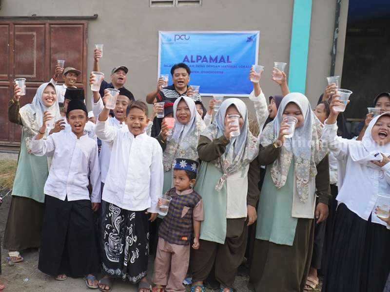 Caption: Para warga di Dusun Tegalsari bersama-sama menikmati air dari ALPAMAL.