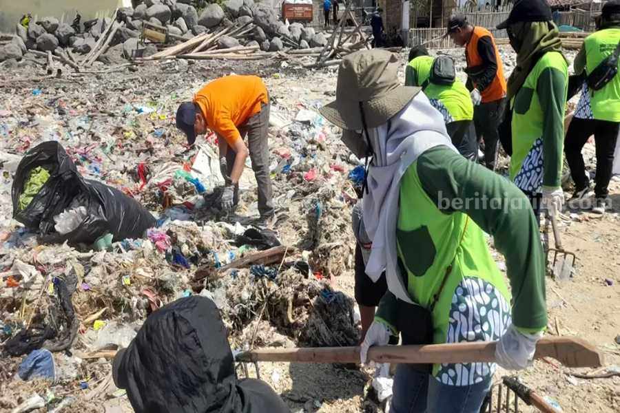 Sejumlah petugas saat membersihkan tumpukan sampah di Pulau Gili Ketapang.
