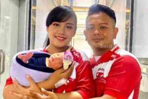 Pasutri suporter Madura United menggendong 'Cinta Madura United'.
