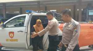Evakuasi perempuan yang hendak bunuh diri oleh polisi Sampang (Foto: Zamachsari/beritajatim.com)