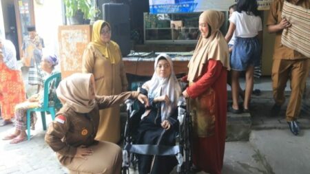 Bupati Mojokerto Ikfina Fahmawati saat menyerahkan bansos berupa kursi roda kepada penyandang disabilitas. [Foto: Dok]