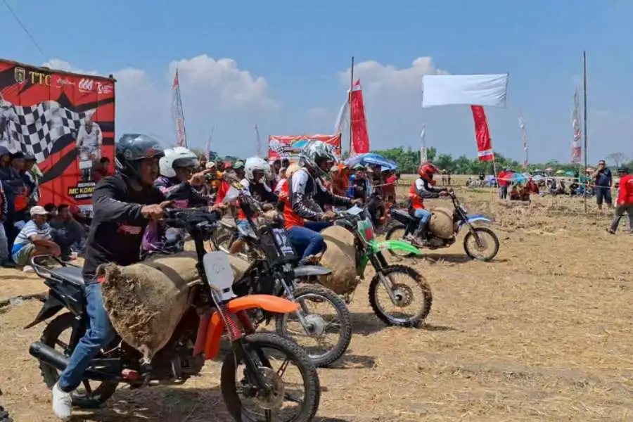 Pengojek gabah saat mnegikuti Balapan Bandangan Grass Track di sawah Desa Mangunharjo, Ngawi, Jawa Timur, Minggu (04/08/2024)