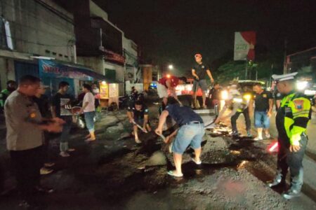 Ada Jalan Berlubang, Relawan dan Polsek Krian Kompak Bertindak Foto BeritaJatim.com